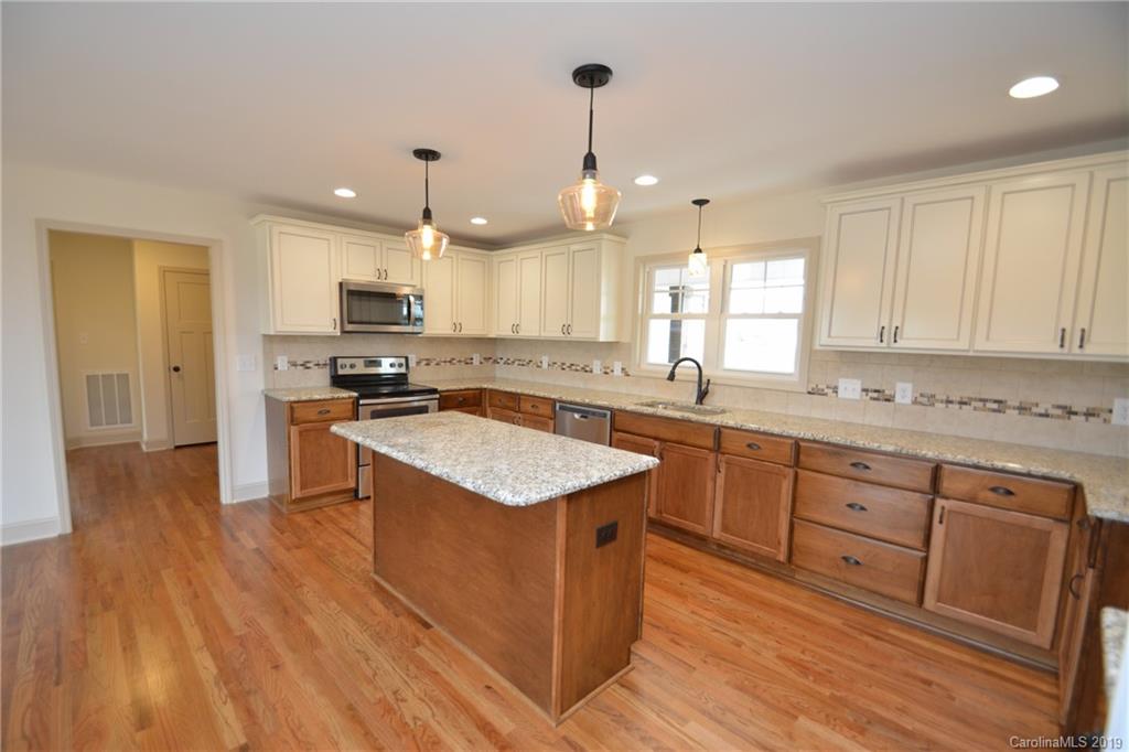 1331 George Brown Road Crouse, NC 28033 - Photo 9 of 39 a kitchen with stainless steel appliances granite countertop a sink a stove and a refrigerator