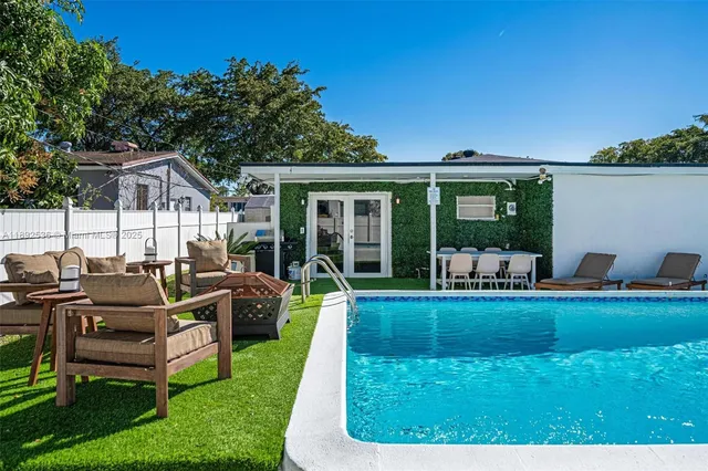 a view of a house with backyard porch and sitting area
