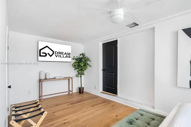 a view of an empty room with window and cabinet