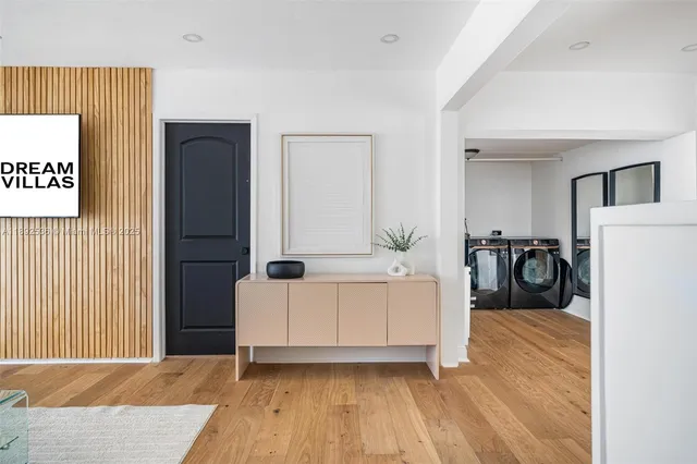 a living room with a bed and a refrigerator