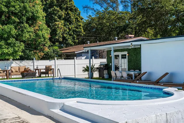 a view of a house with backyard porch and sitting area