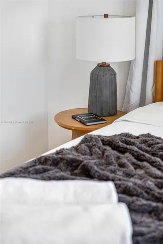 a bedroom with a bed and a lamp