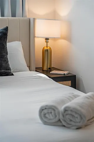 a bedroom with a bed and a mirror