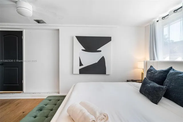 a bedroom with a bed and window