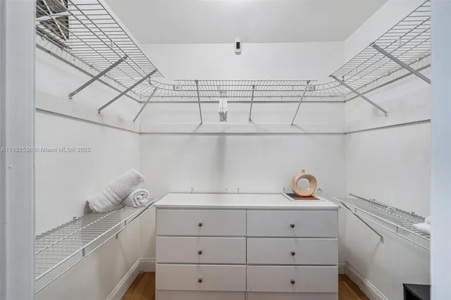a view of a kitchen with white cabinets and sink