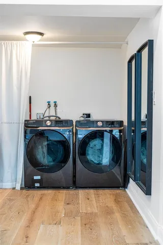 a utility room with two washing machine and a sink