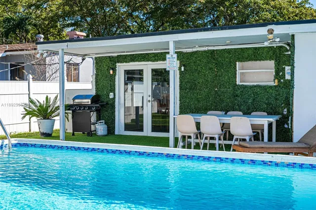 a view of a house with a backyard porch and sitting area