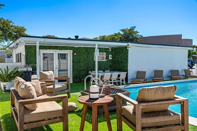 a view of a patio with table and chairs and potted plants