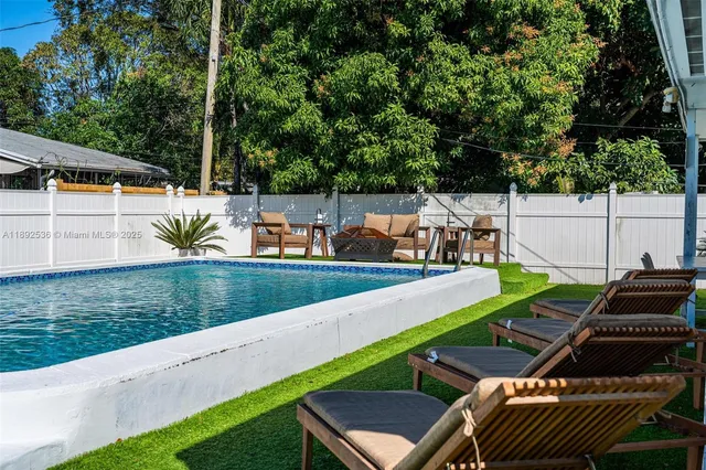 a view of a yard with furniture and lake view