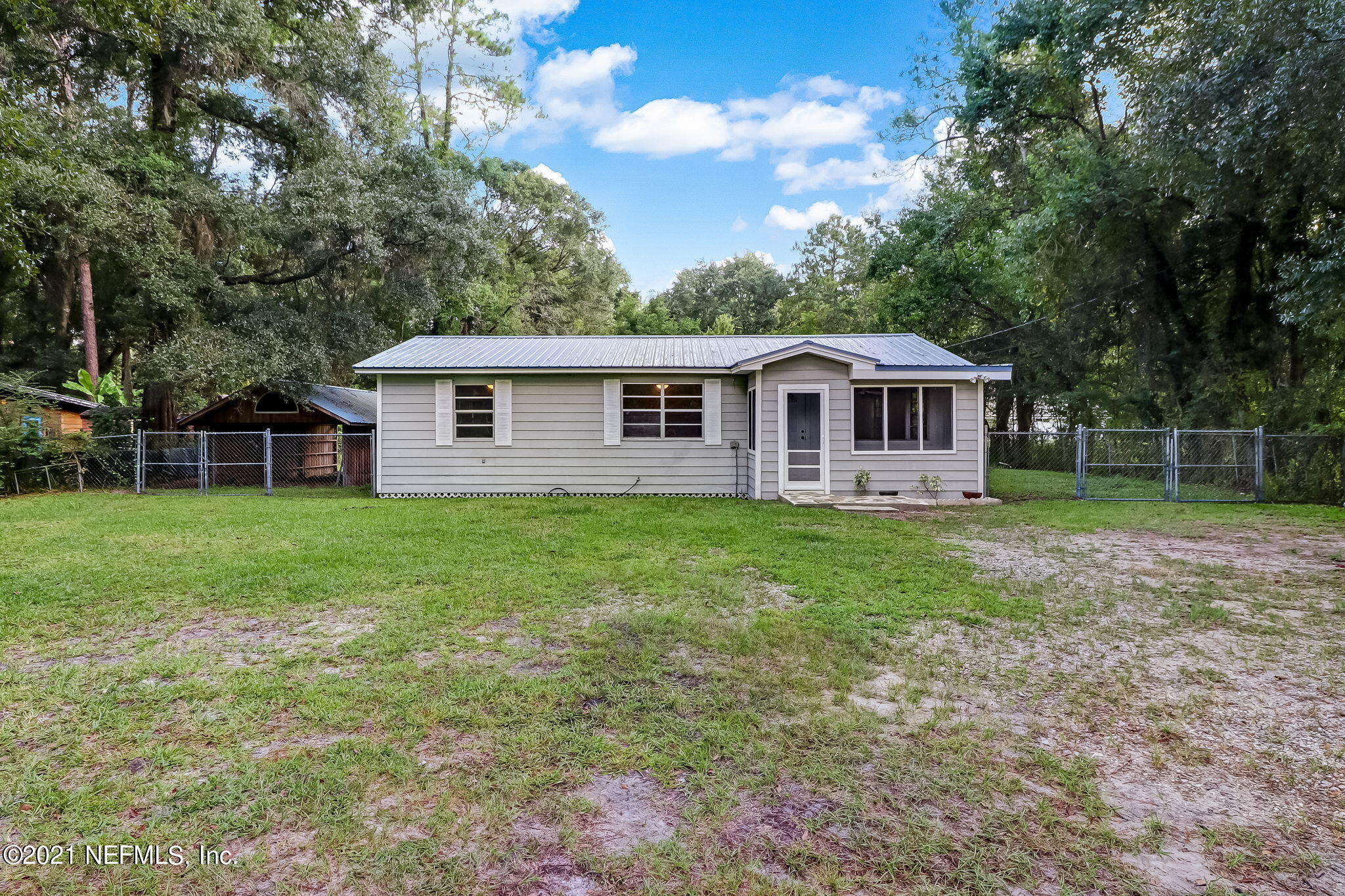 541754 Lem Turner Road Callahan, FL 32011 - Photo 2 of 27 a front view of a house with a yard table and chairs