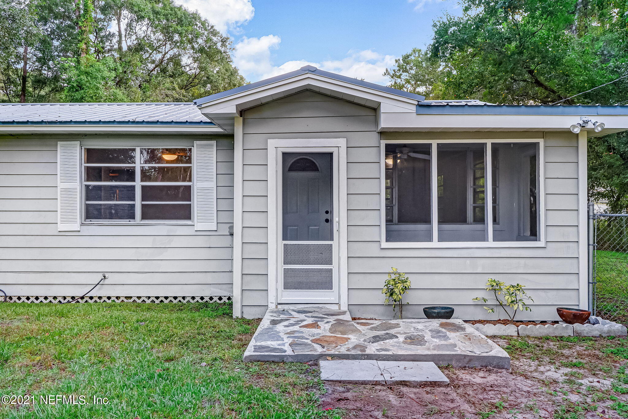 541754 Lem Turner Road Callahan, FL 32011 - Photo 3 of 27 a front view of a house with garden