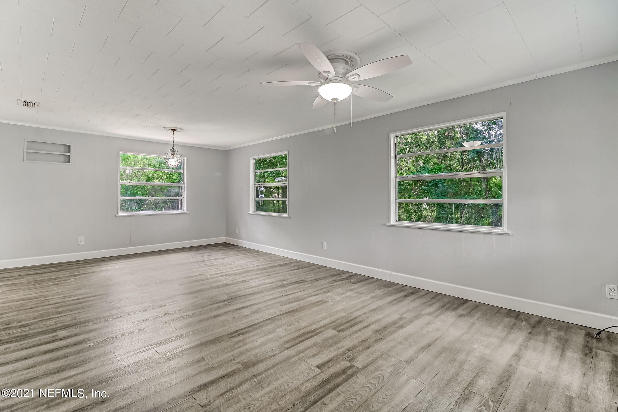 541754 Lem Turner Road Callahan, FL 32011 - Photo 6 of 27 a view of an empty room with wooden floor and window