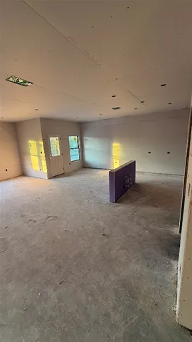 en empty room with window and fireplace