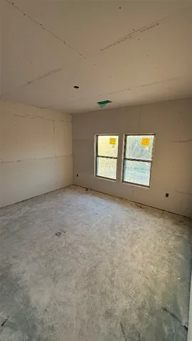 an empty room with a kitchen and a sink