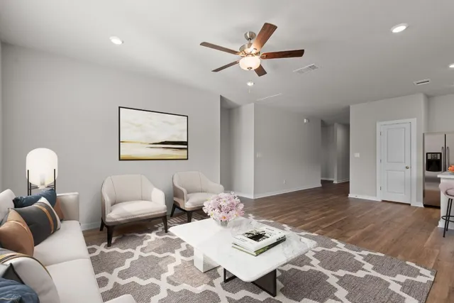 a living room with furniture and wooden floor