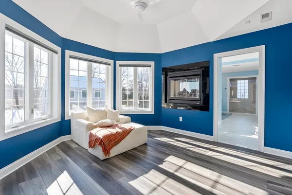 a living room with couch and large windows