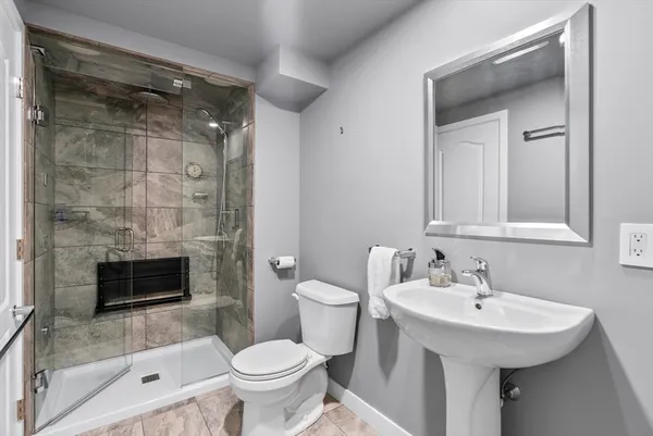 a bathroom with a sink toilet and shower