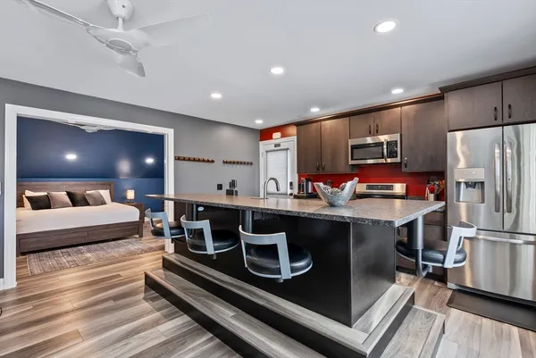 a kitchen with kitchen island a stove and a refrigerator