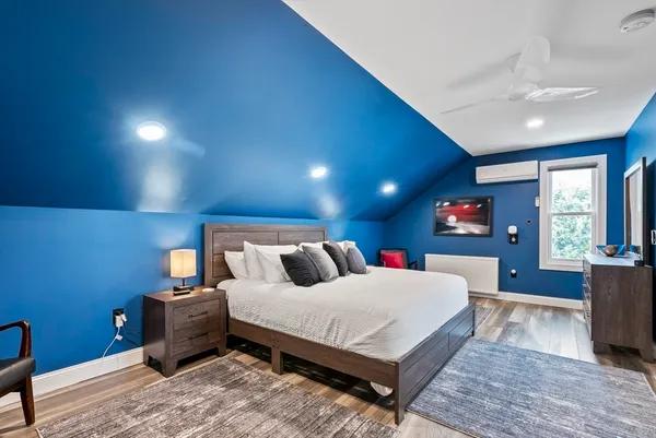 a bedroom with a large bed and a couch