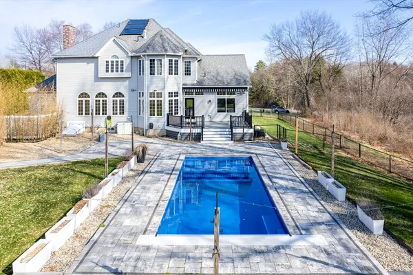 a view of house with backyard outdoor seating and swimming pool