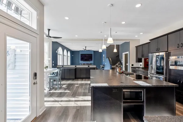a large kitchen with a table and chairs