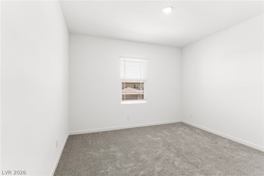 320 Isla Enclave Way Henderson, NV 89011 - Photo 34 of 49 Minimalist bedroom with neutral carpeting and natural light provides a serene retreat.