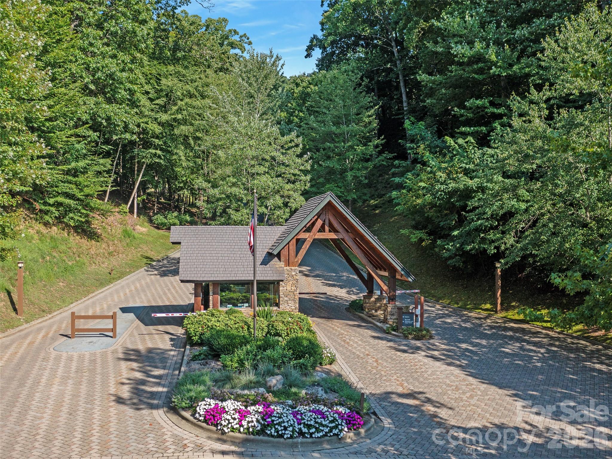 Lot 4 Heritage Ridge Road Burnsville, NC 28714 - Photo 18 of 28 a view of a house with a small yard and large trees