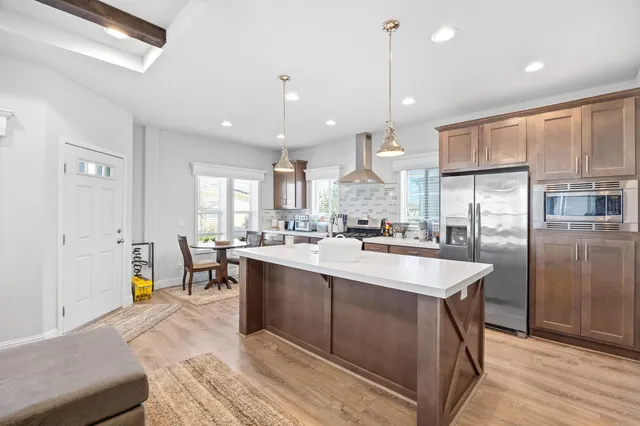 a large kitchen with a large counter top appliances and cabinets