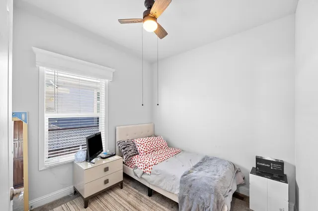 a bedroom with a bed and a window