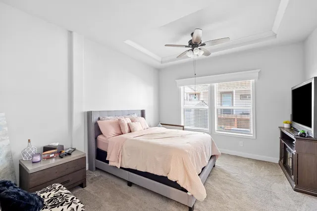 a bedroom with a bed furniture and a flat tv screen