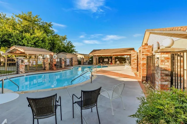 a view of a swimming pool with an outdoor seating