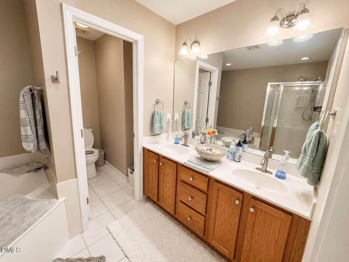 120 Student Place Durham, NC 27713 - Photo 10 of 15 a bathroom with a double vanity sink a toilet and a mirror