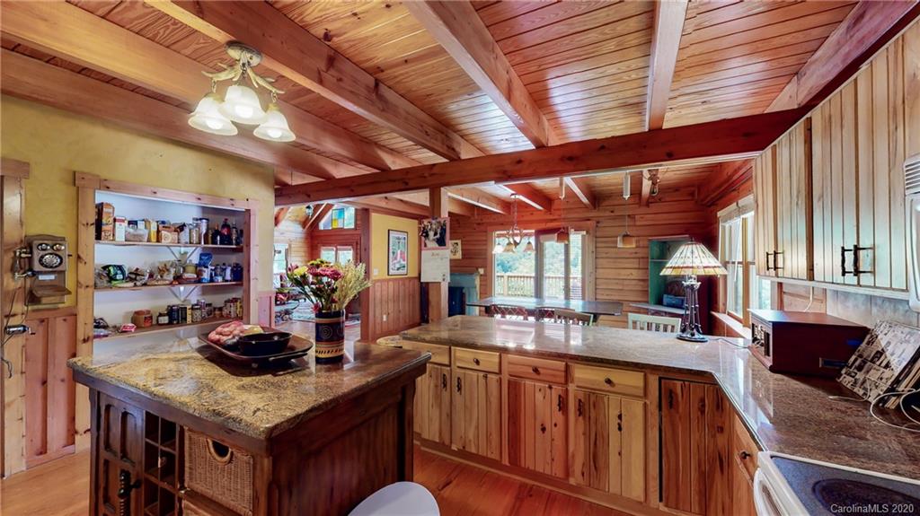 1823 Barnard Road Marshall, NC 28753 - Photo 22 of 48 a kitchen with stainless steel appliances granite countertop a large stove a sink dishwasher and cabinets with wooden floor