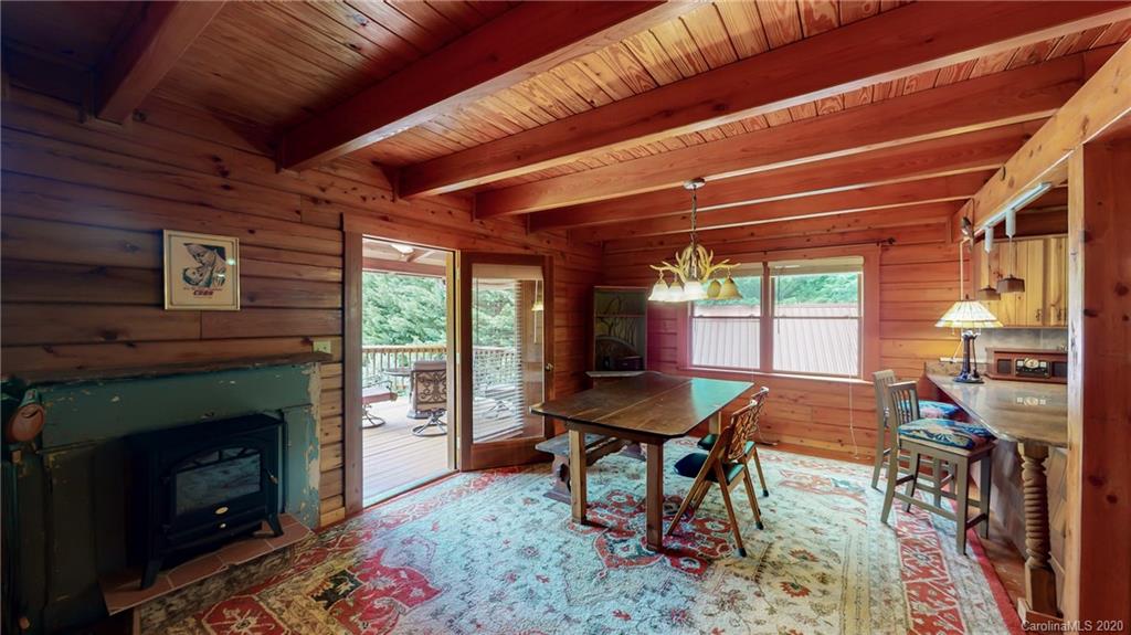 1823 Barnard Road Marshall, NC 28753 - Photo 6 of 48 a dining room with furniture and a fireplace