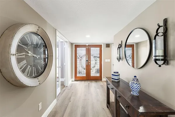 a large kitchen with stainless steel appliances lots of counter space and wooden floors