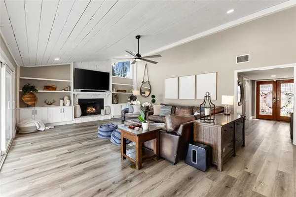 a kitchen with stainless steel appliances kitchen island granite countertop a dining table and chairs