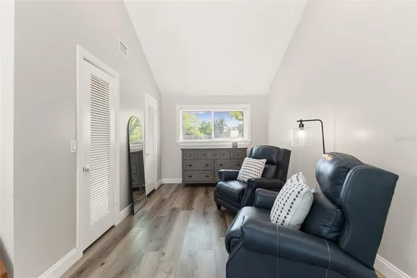 a living room with furniture and a floor to ceiling window