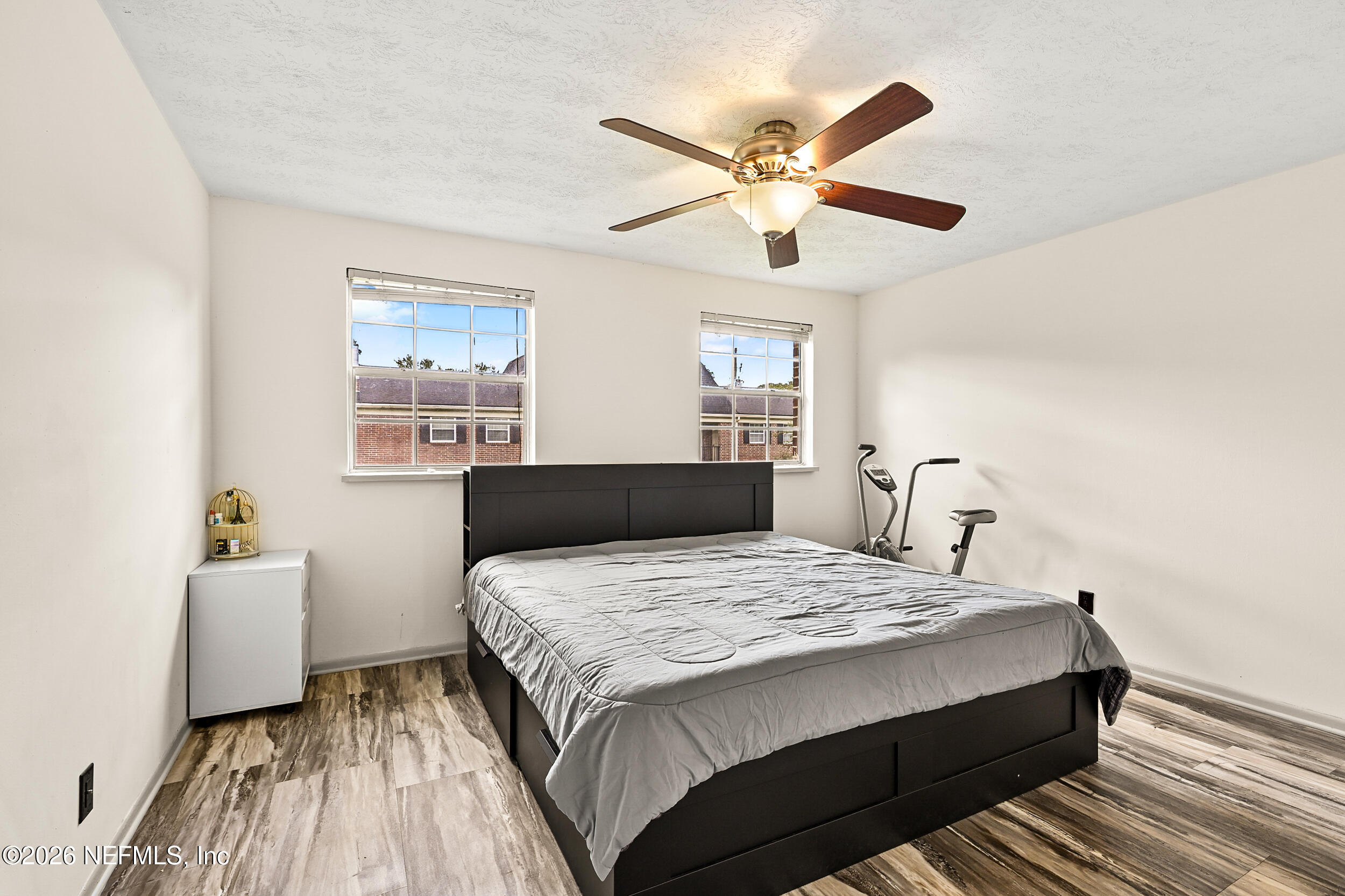 4915 Baymeadows Road, Unit 6G Jacksonville, FL 32217 - Photo 16 of 44 a bedroom with a large bed and a chandelier