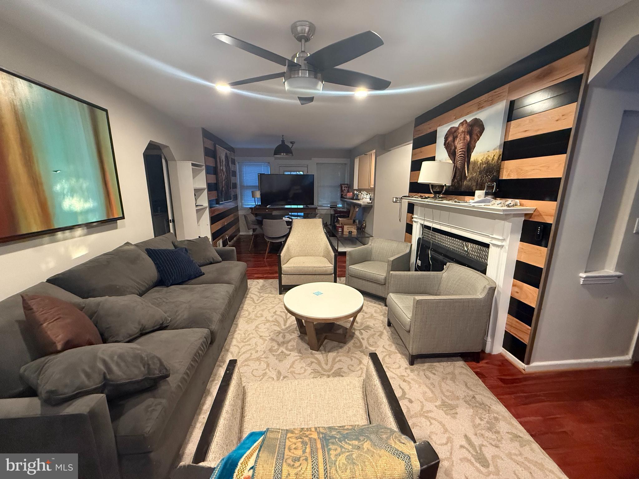 5603 Hawthorne Street Cheverly, MD 20785 - Photo 19 of 88 a living room with furniture a fireplace and a flat screen tv
