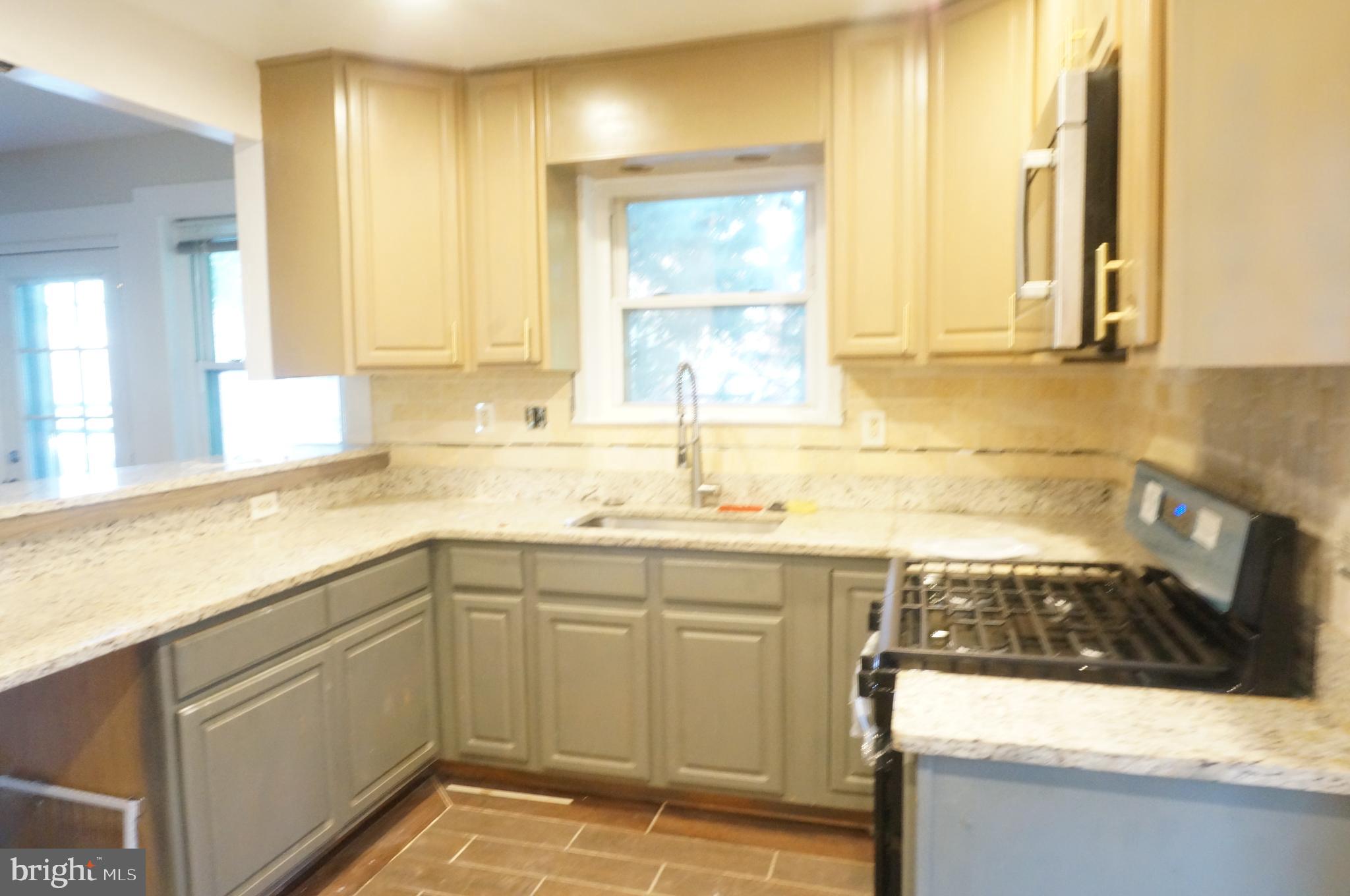 5603 Hawthorne Street Cheverly, MD 20785 - Photo 27 of 88 a kitchen with a sink stove and cabinets
