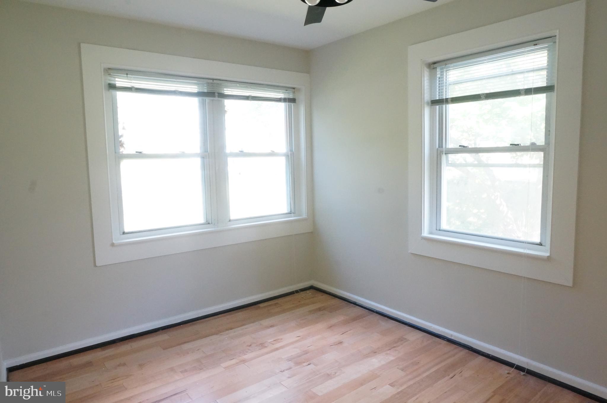 5603 Hawthorne Street Cheverly, MD 20785 - Photo 36 of 88 a view of an empty room with wooden floor and a window