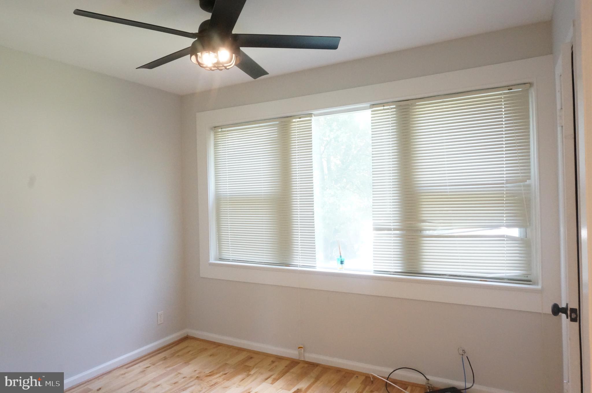 5603 Hawthorne Street Cheverly, MD 20785 - Photo 44 of 88 a view of empty room with wooden floor and fan