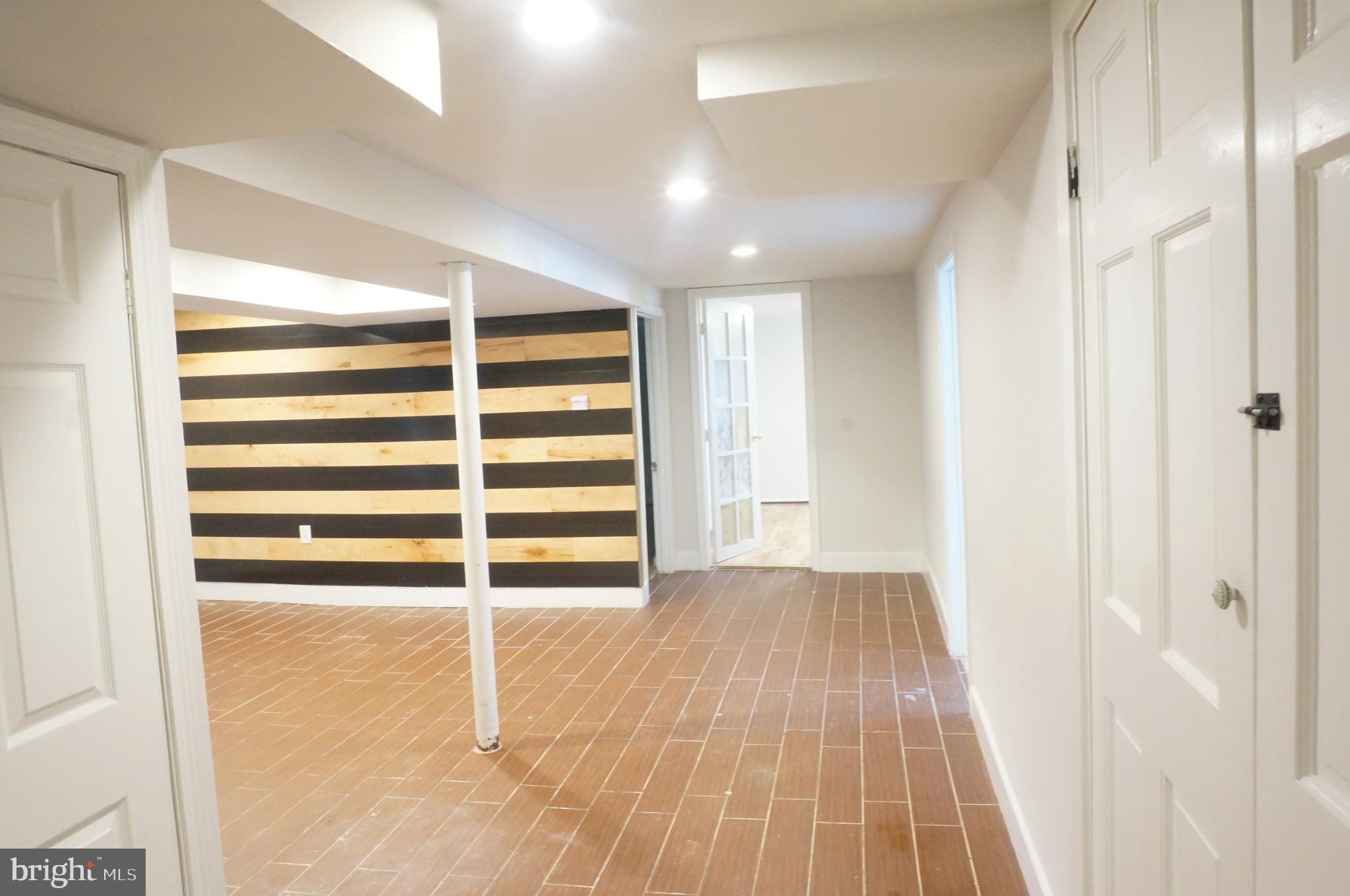 5603 Hawthorne Street Cheverly, MD 20785 - Photo 59 of 88 a view of a room with wooden floor and windows
