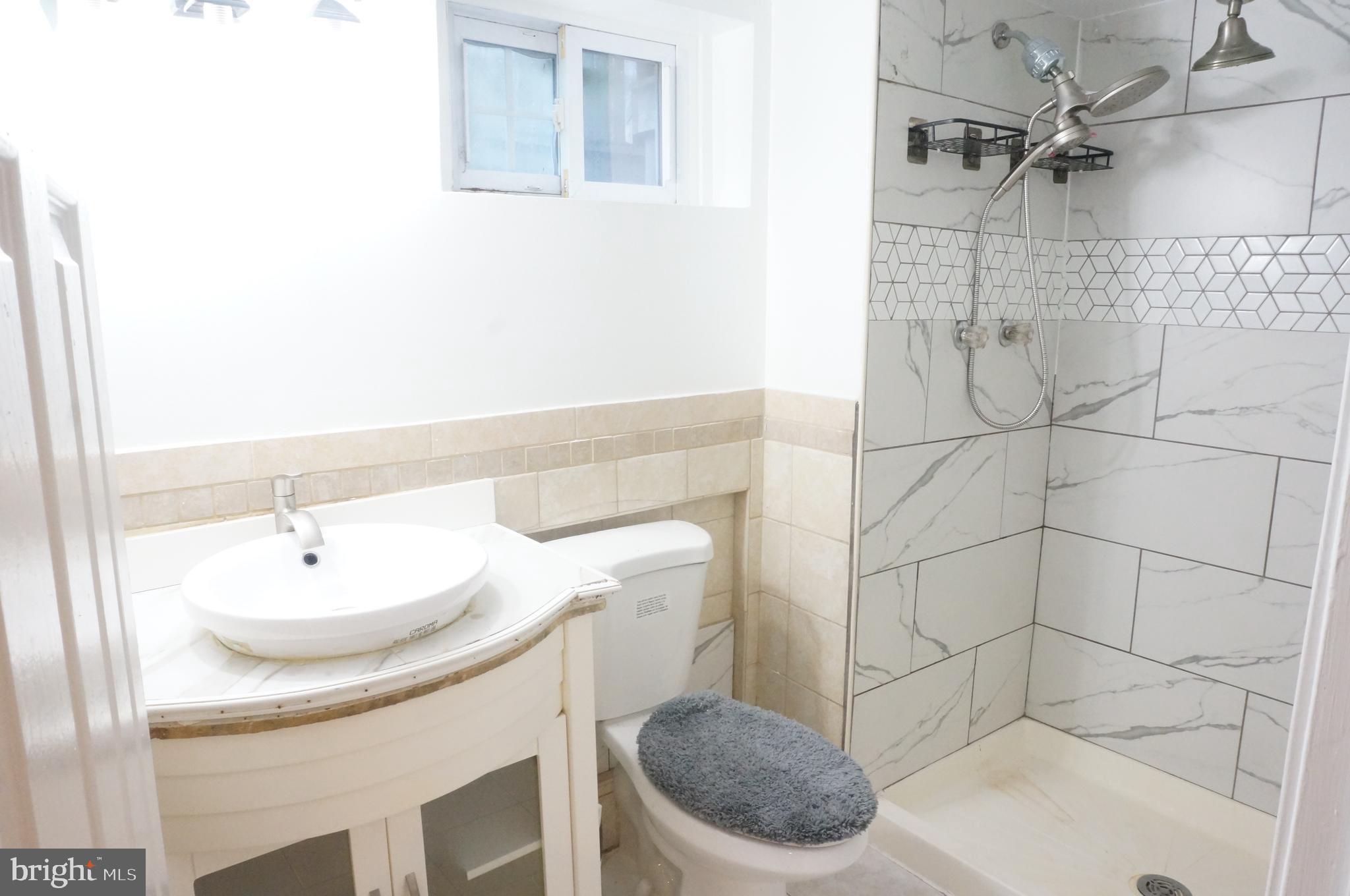 5603 Hawthorne Street Cheverly, MD 20785 - Photo 65 of 88 a bathroom with a sink a toilet and shower