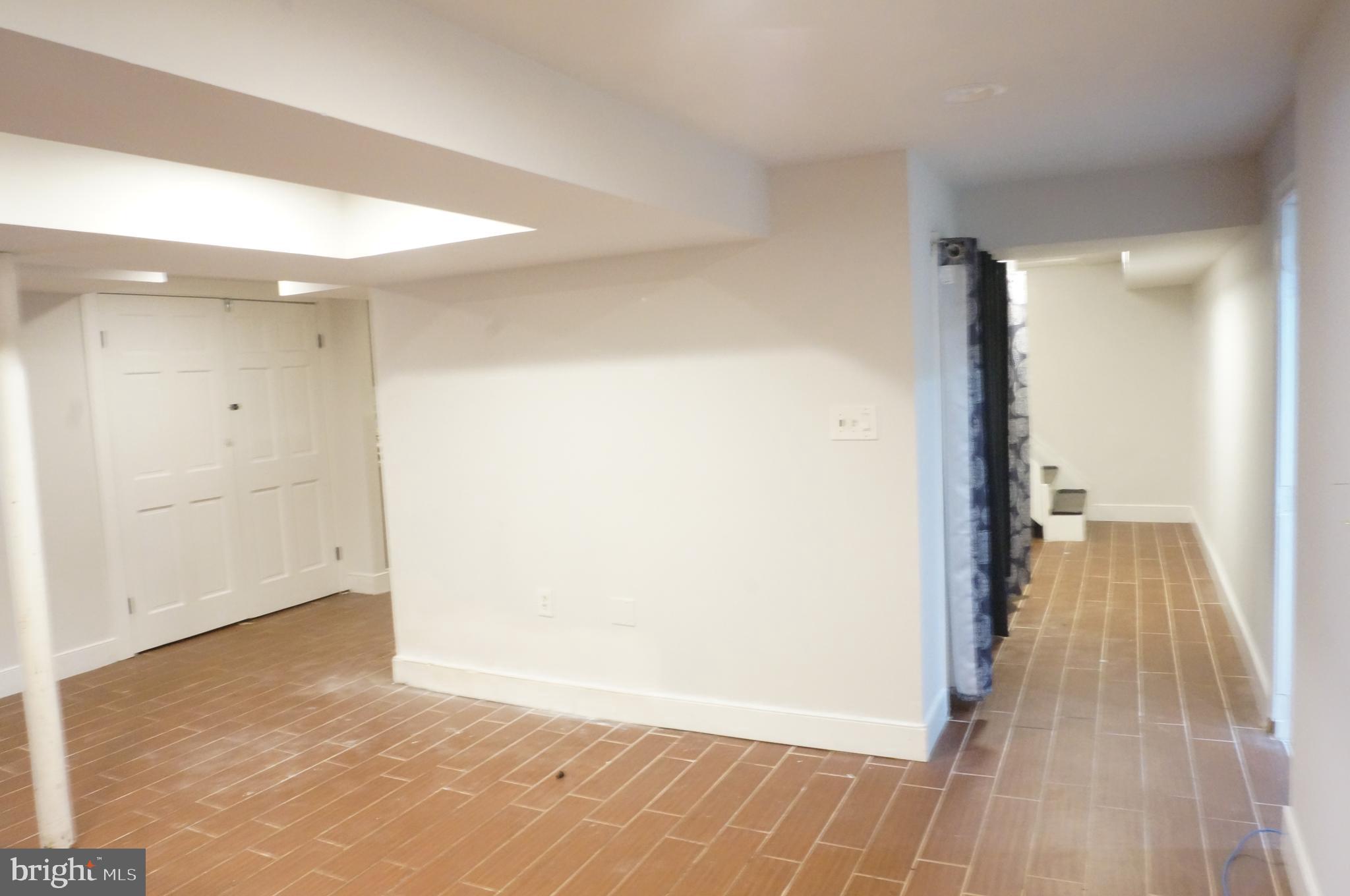5603 Hawthorne Street Cheverly, MD 20785 - Photo 67 of 88 a view of a hallway with wooden floor