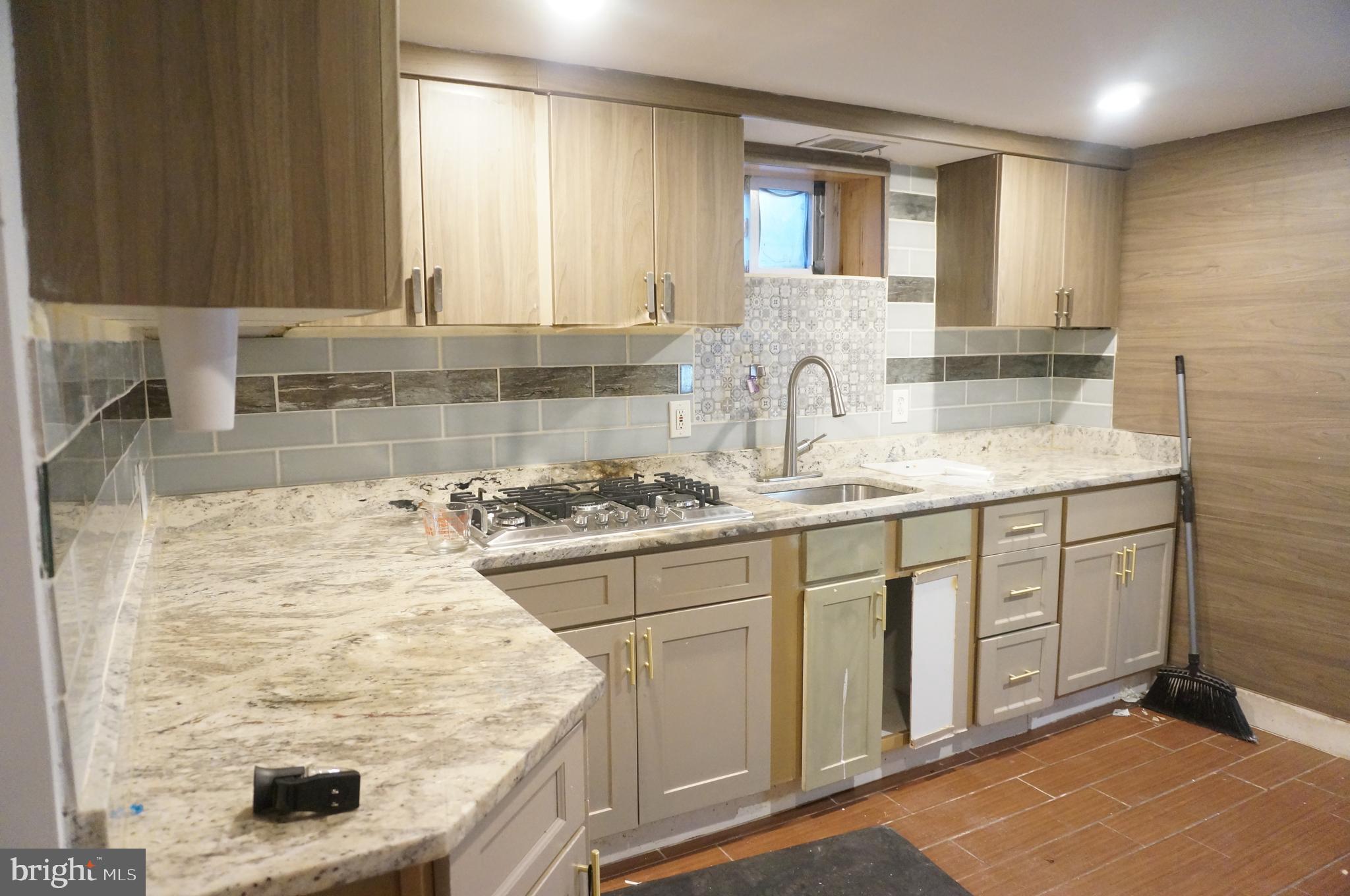 5603 Hawthorne Street Cheverly, MD 20785 - Photo 71 of 88 a kitchen with stainless steel appliances granite countertop a sink stove and cabinets