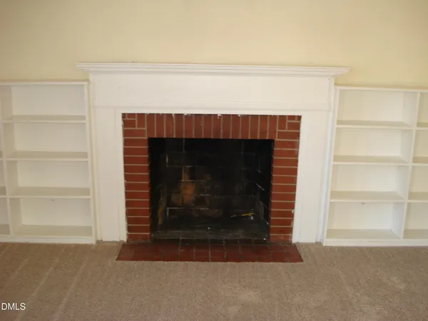 an empty room with closet and a bathroom