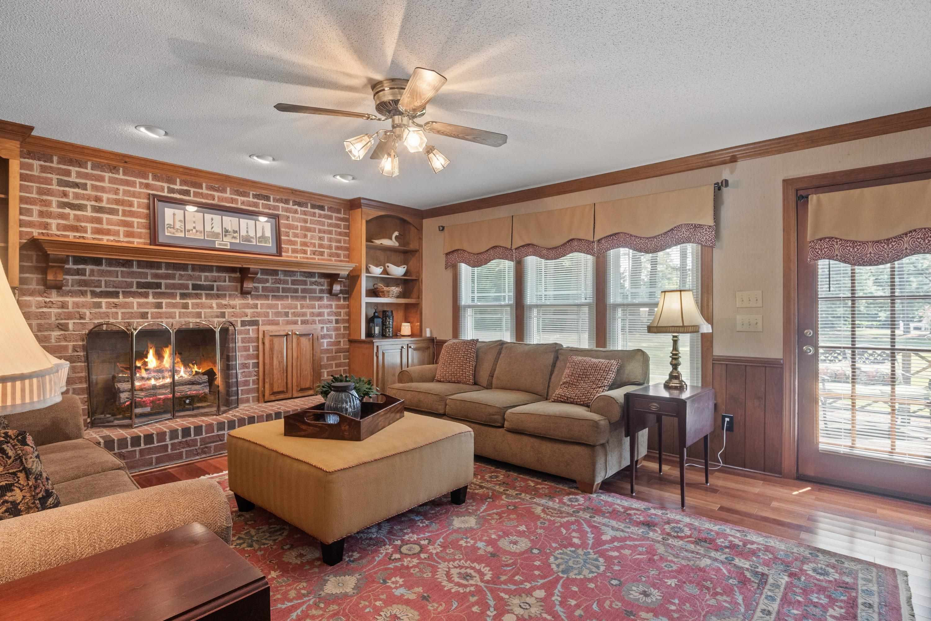 8501 Crowder Road Raleigh, NC 27603 - Photo 21 of 60 Perfect for entertaining with beautiful brick fireplace w/ gas logs and door to back deck Den/Family/Great Room