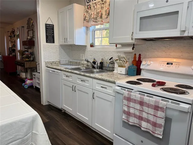a kitchen with kitchen island a sink stove and cabinets