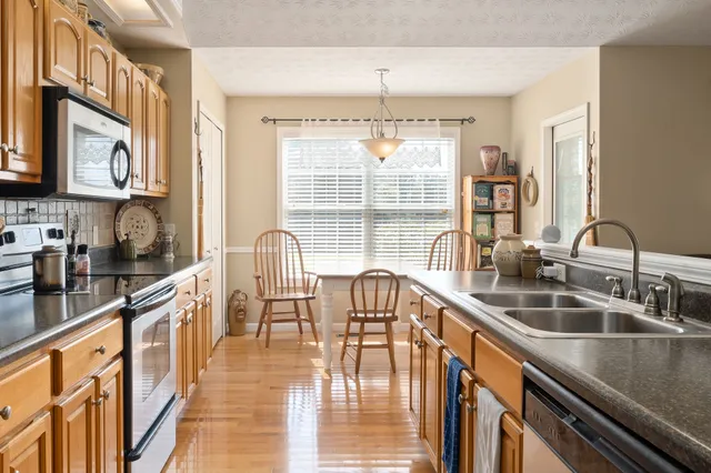 a kitchen with granite countertop a sink and a stove top oven